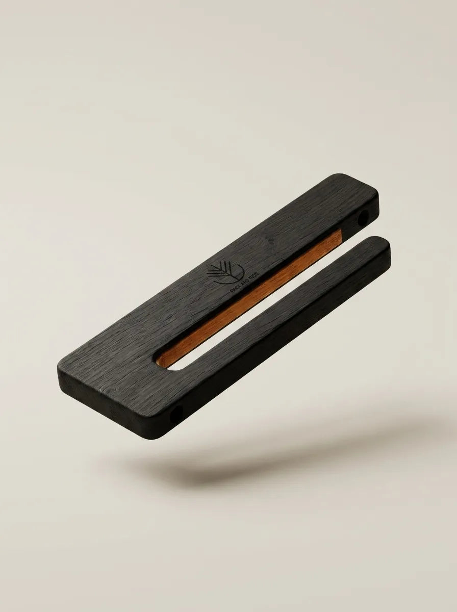 Black-tinted oak Rack and Ride vertical skateboard wall mount framing a colourful deck like a gallery wall