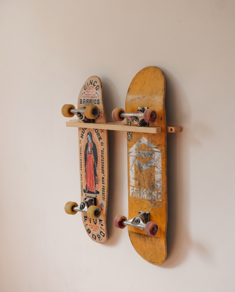 Two skateboards mounted side by side on the bamboo double wall mount