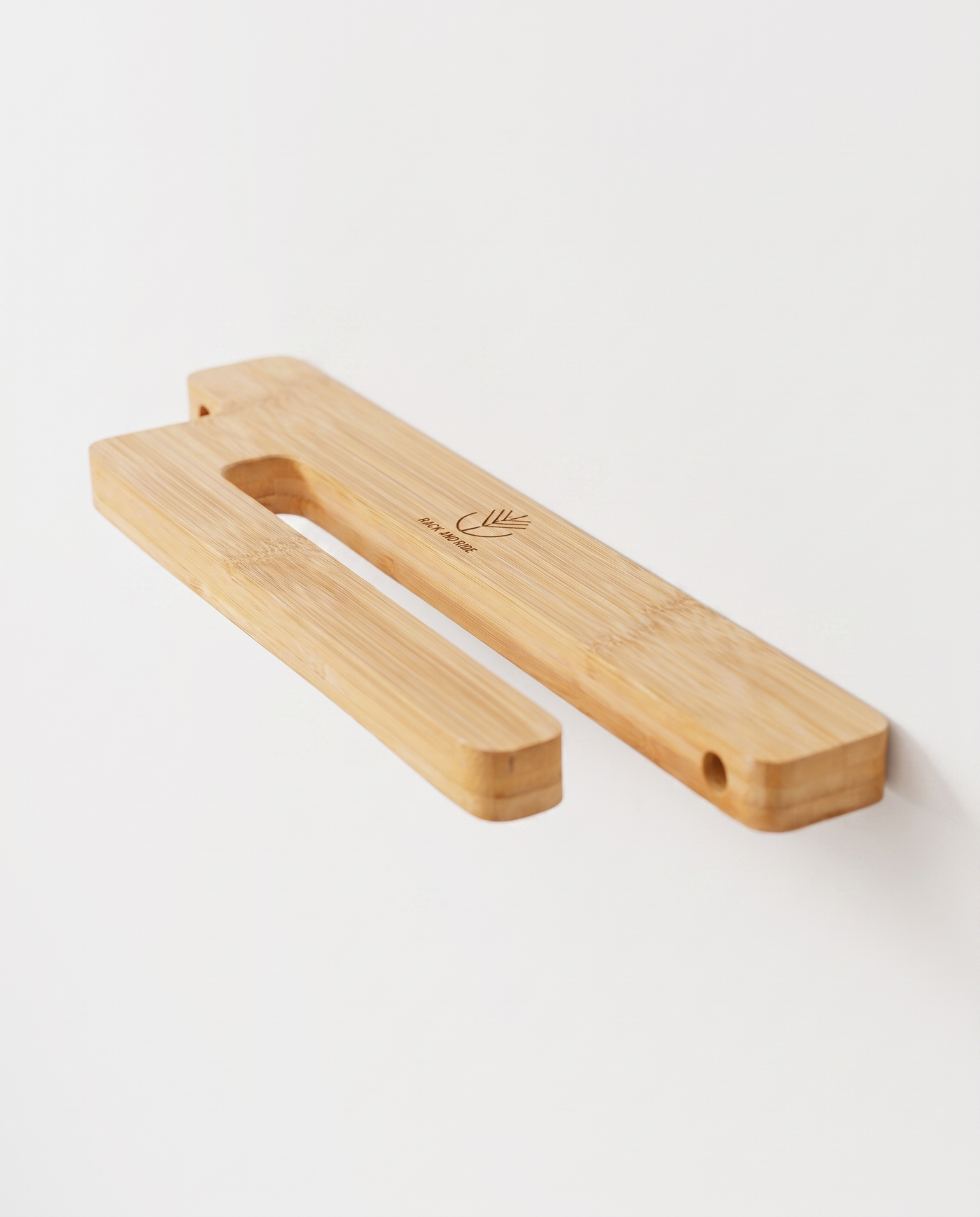 Bamboo vertical skateboard wall mount mounted empty on a white wall