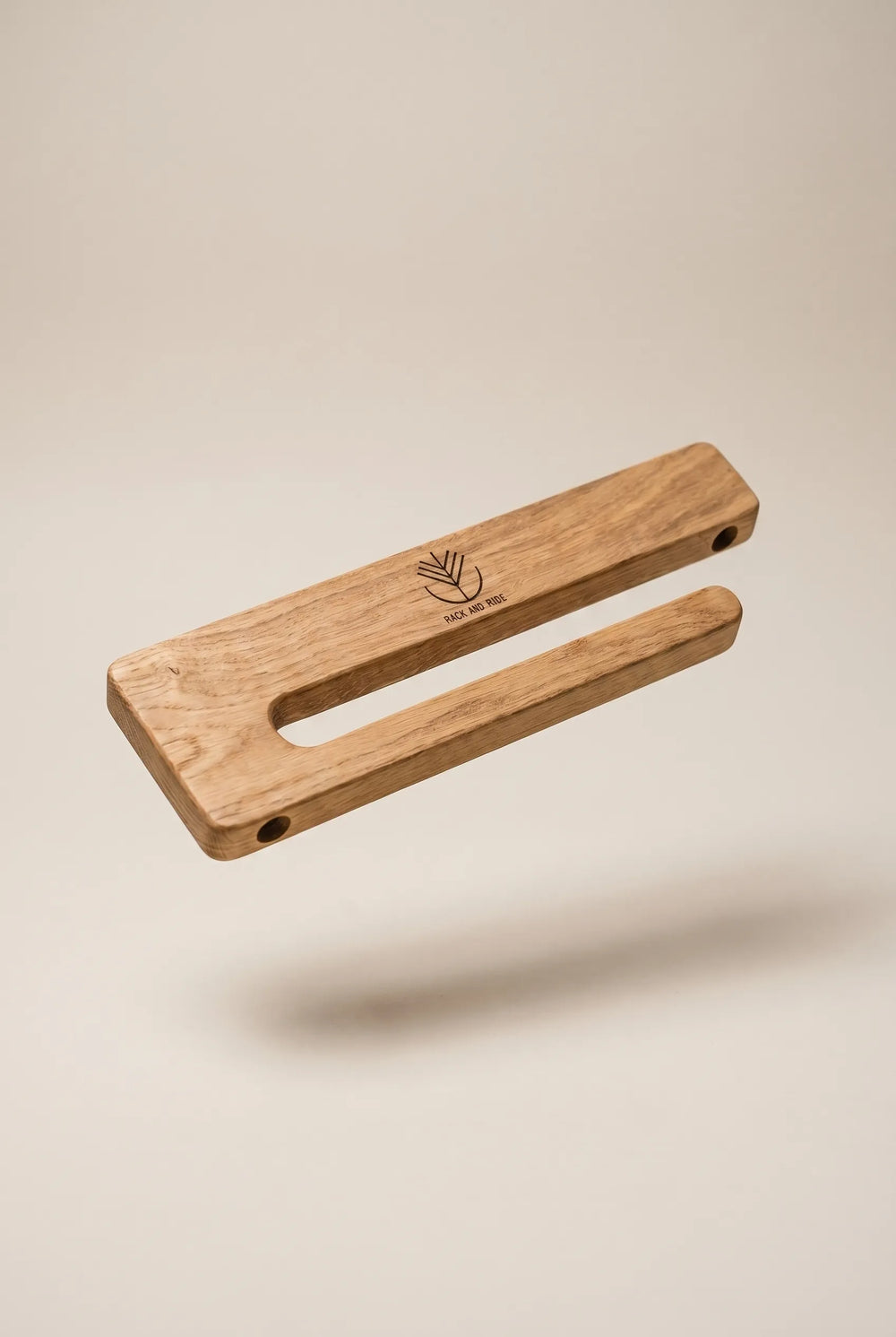 Soporte de pared de roble que sujeta un skate por los ejes, con el gráfico de la tabla visible e intacto