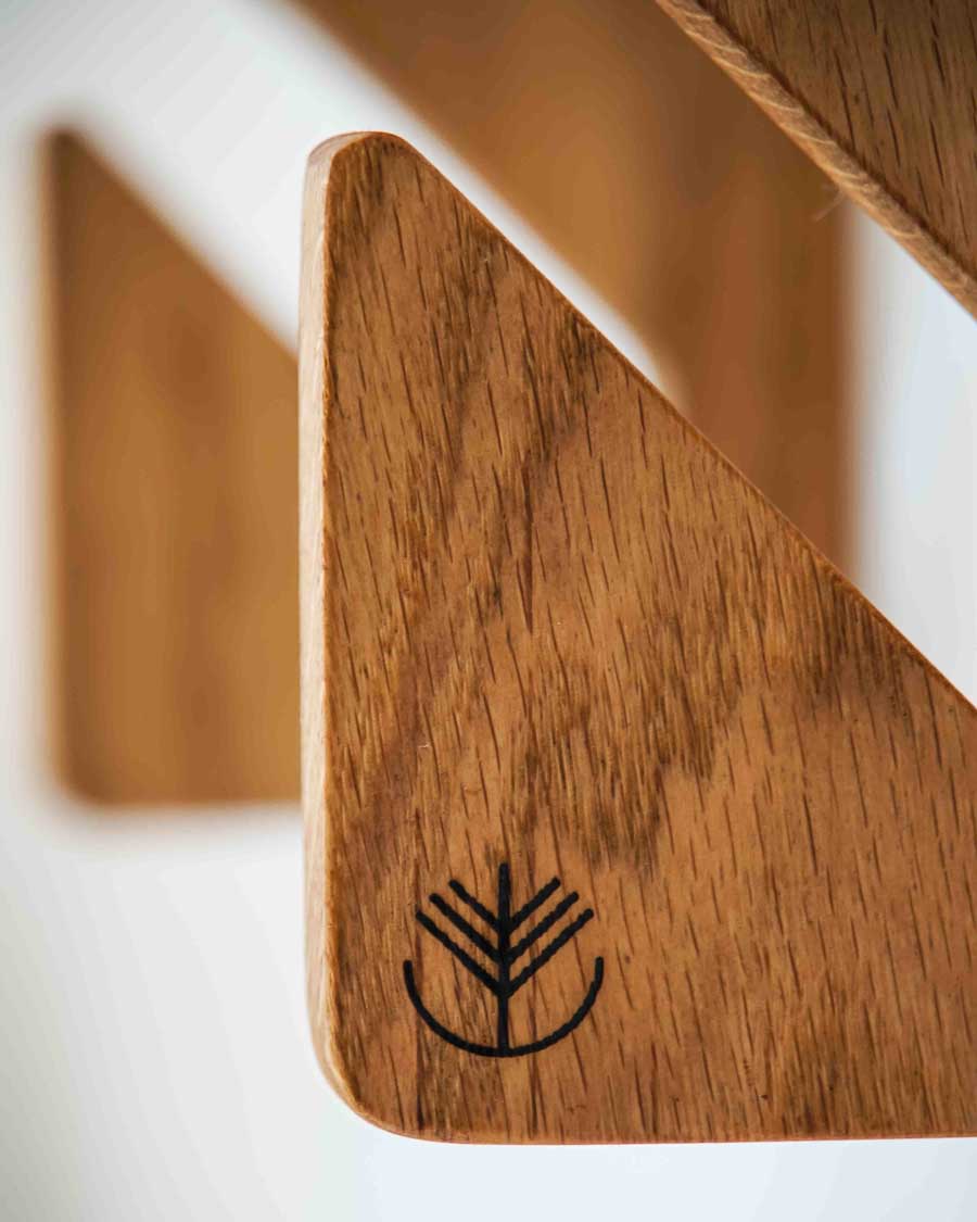 Solid oak triple boardsport wall rack for a full quiver of boards